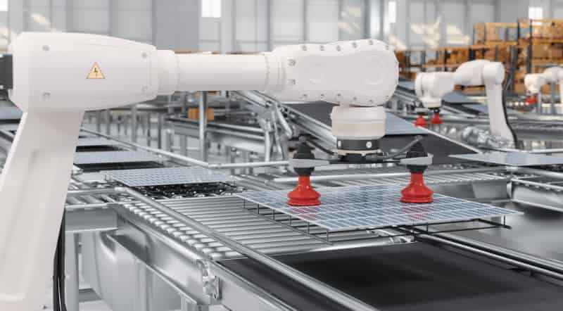 White industrial robots performing pick-and-place tasks on a production line, demonstrating high-speed factory automation and logistics.