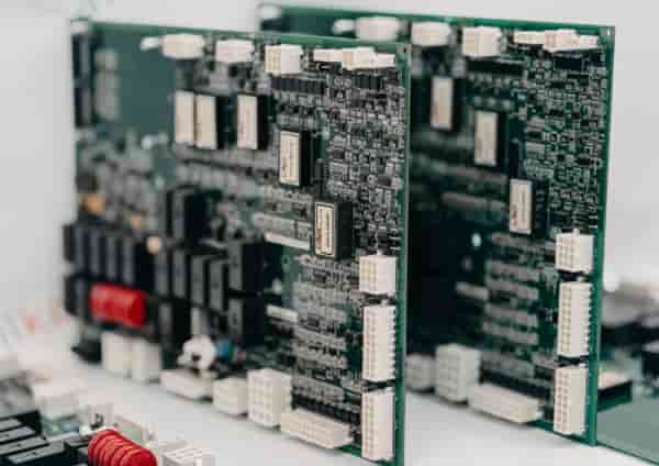 Industrial control system circuit boards with connectors and components, representing automation hardware and electronic module manufacturing.